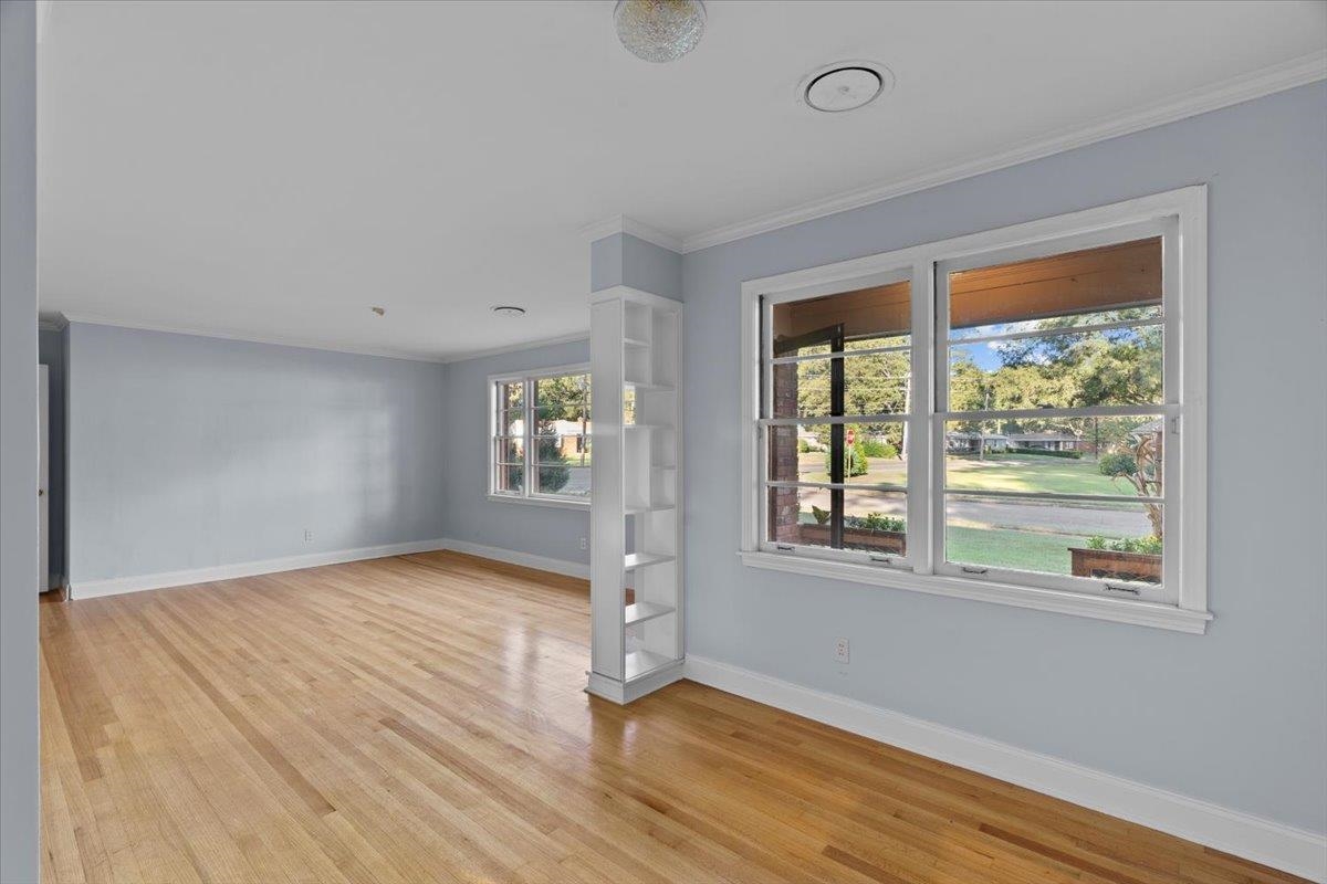 1495 Whitewater Road Memphis, TN 38117 - Photo 6 of 27 a view of an empty room with wooden floor and a window