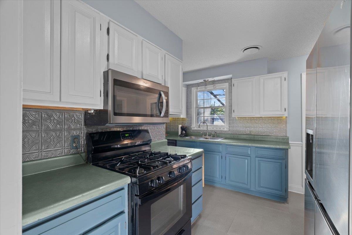 1495 Whitewater Road Memphis, TN 38117 - Photo 7 of 27 a kitchen with granite countertop a stove and a sink