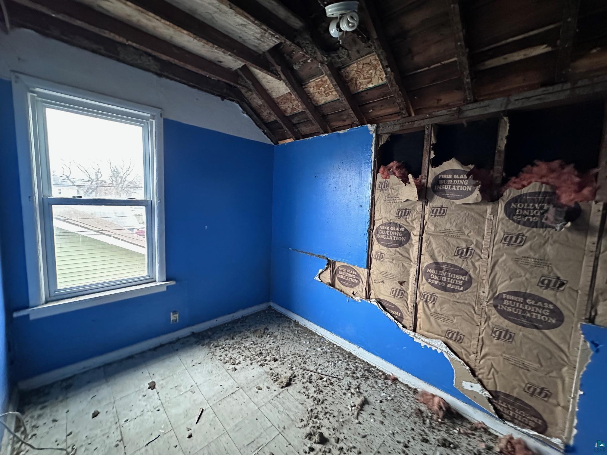 1314-1316 North 11th Street Superior, WI 54880 - Photo 3 of 21 Unfurnished bedroom with lofted ceiling and baseboards