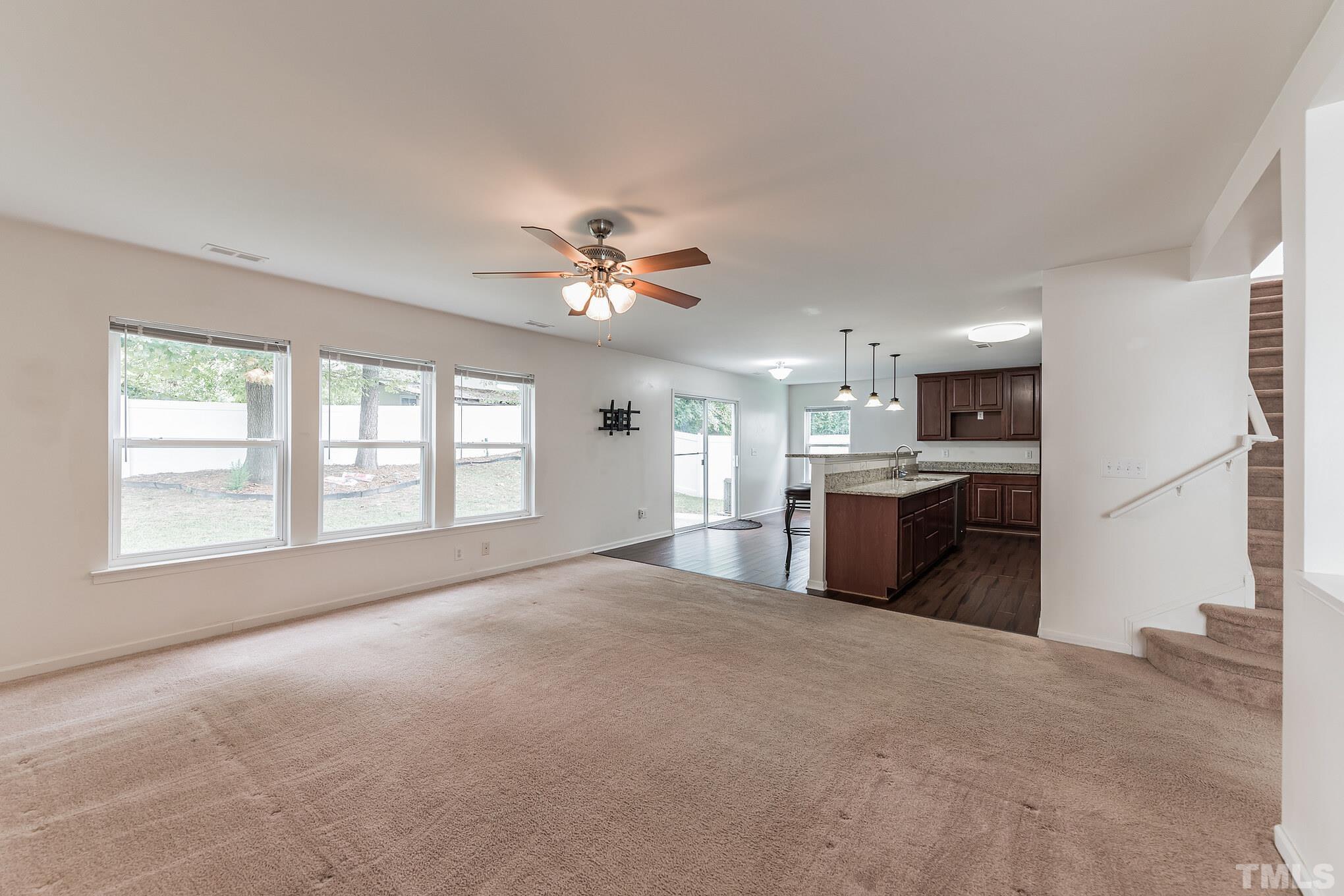 2824 Roundleaf Court Raleigh, NC 27604 - Photo 11 of 35 a open kitchen with stainless steel appliances kitchen island a sink dishwasher a stove and a large window