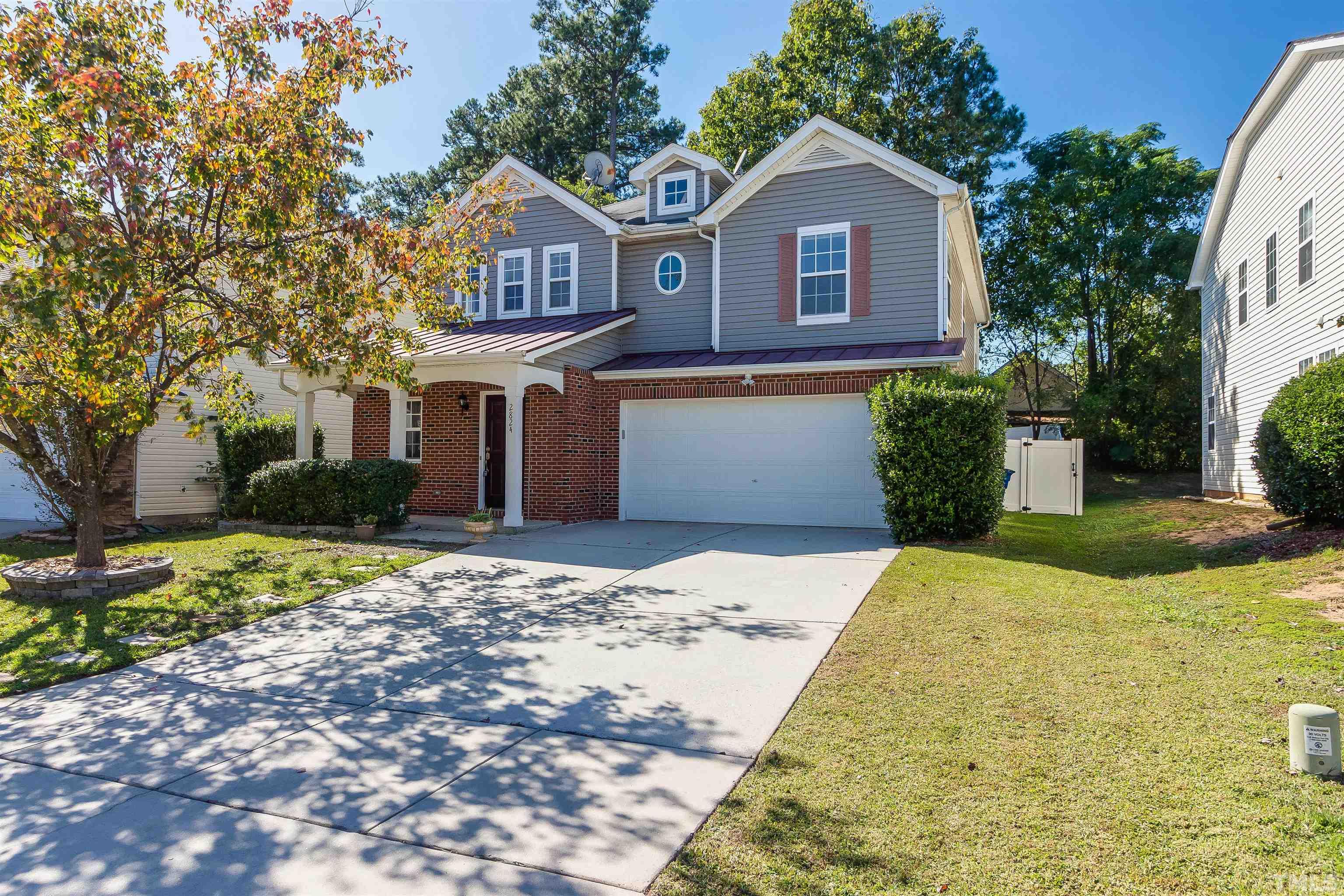 2824 Roundleaf Court Raleigh, NC 27604 - Photo 29 of 35 a front view of a house with a yard and trees