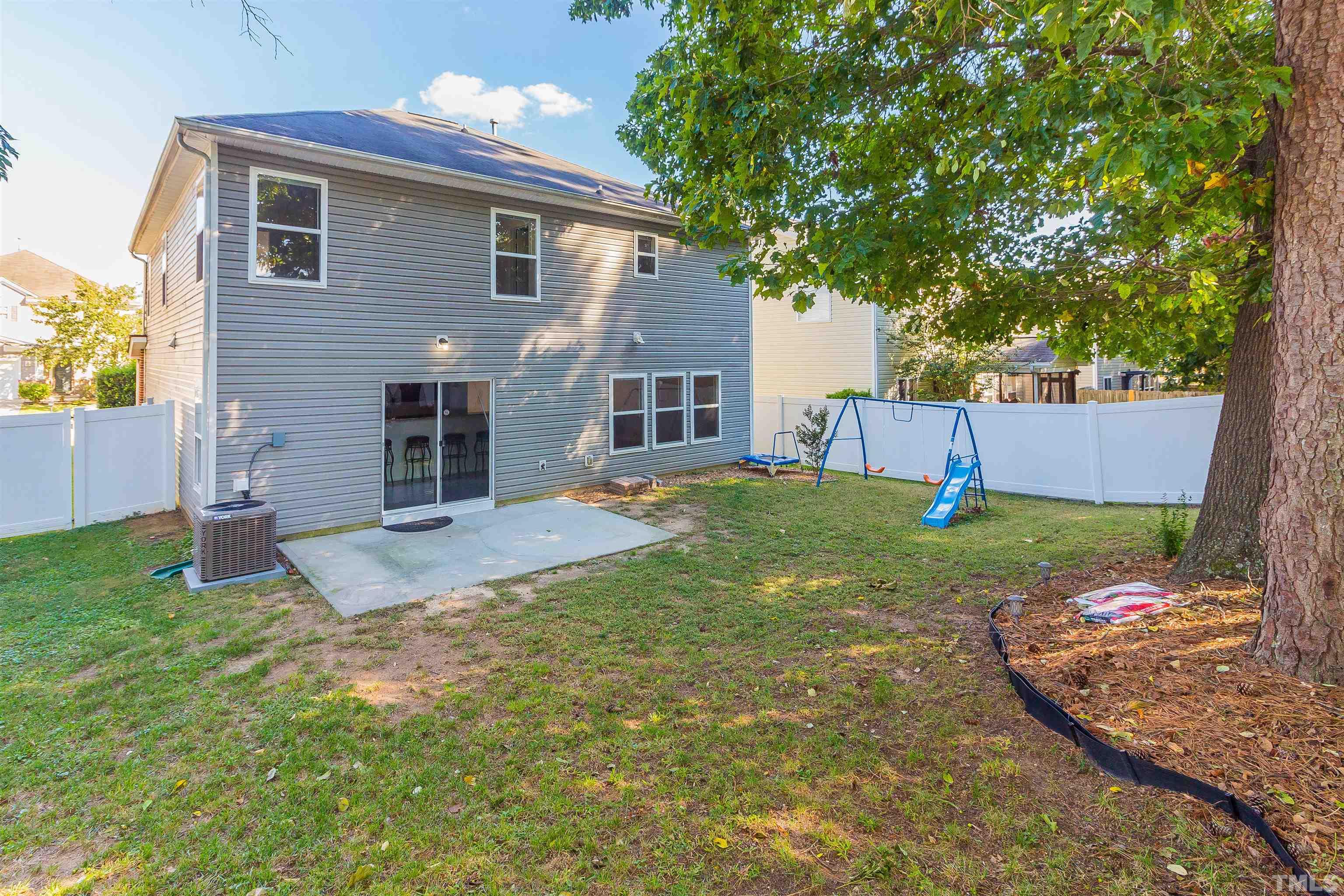 2824 Roundleaf Court Raleigh, NC 27604 - Photo 35 of 35 a view of a house with a yard and a large tree
