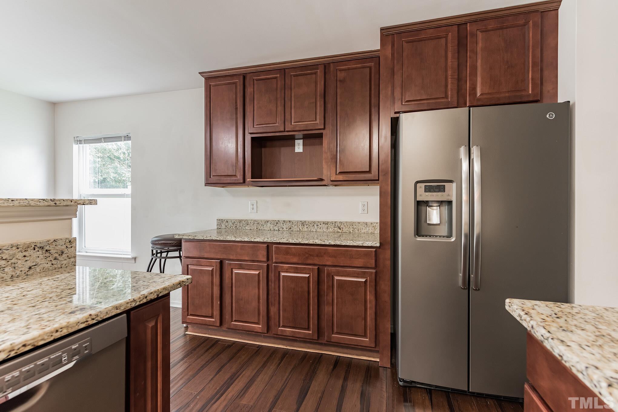 2824 Roundleaf Court Raleigh, NC 27604 - Photo 8 of 35 a kitchen with stainless steel appliances granite countertop a refrigerator a stove a sink and dishwasher with wooden floor