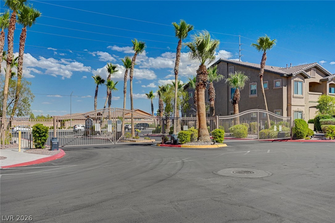 8985 South Durango Drive, Unit 2187 Las Vegas, NV 89113 - Photo 62 of 73 Palm trees line the entrance to this gated community, offering security and a tropical aesthetic.