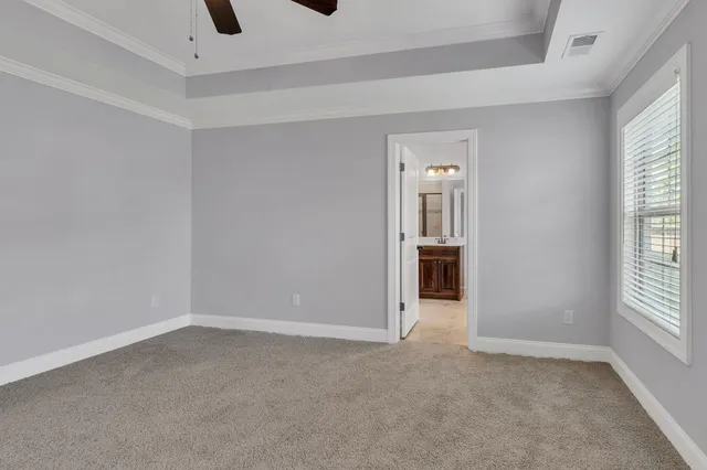 an empty room with windows and cabinet