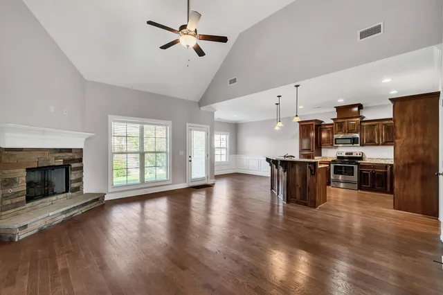 a open kitchen with cabinets and wooden floor