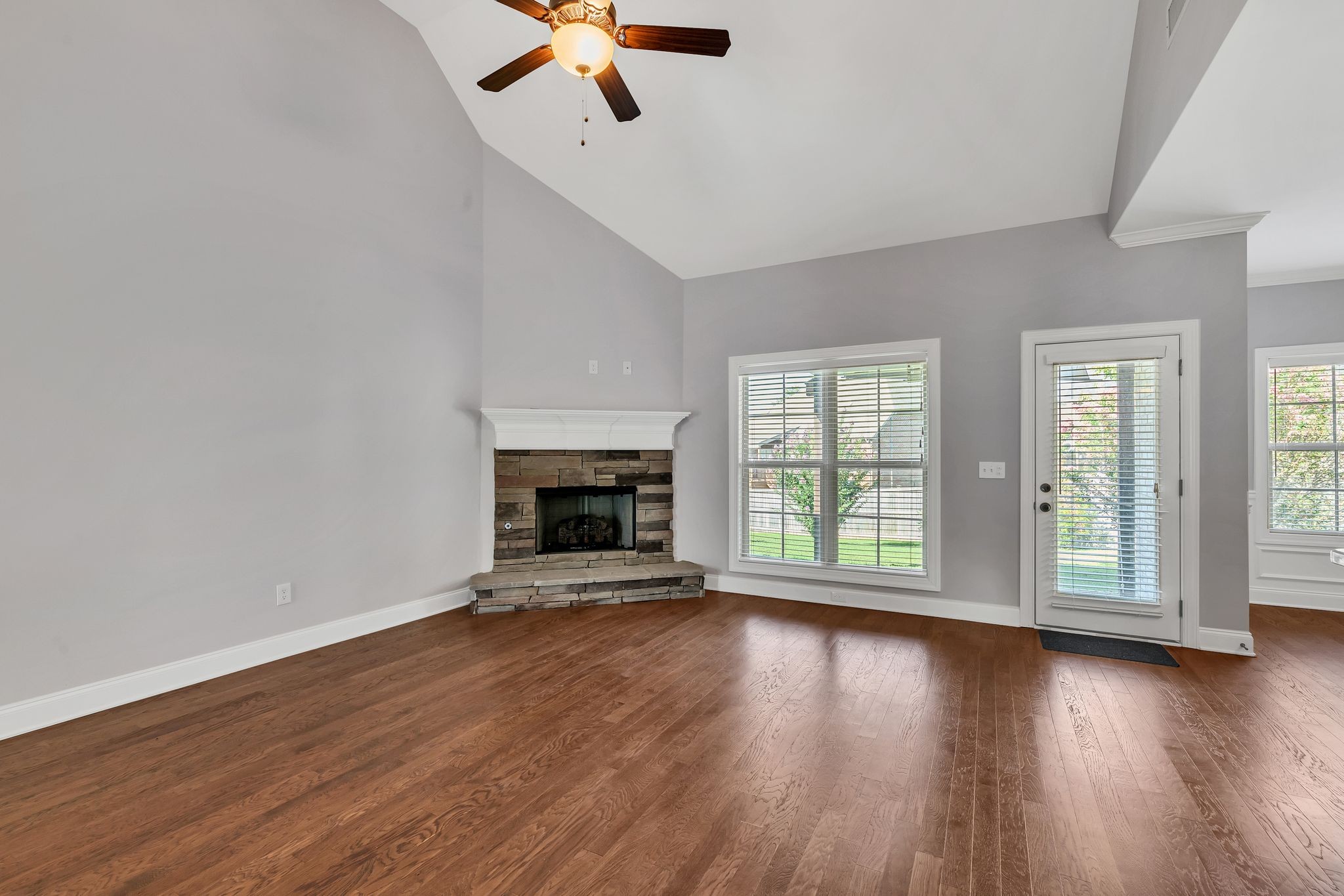 5502 Reflection Road Smyrna, TN 37167 - Photo 4 of 36 an empty room with wooden floor fan and windows