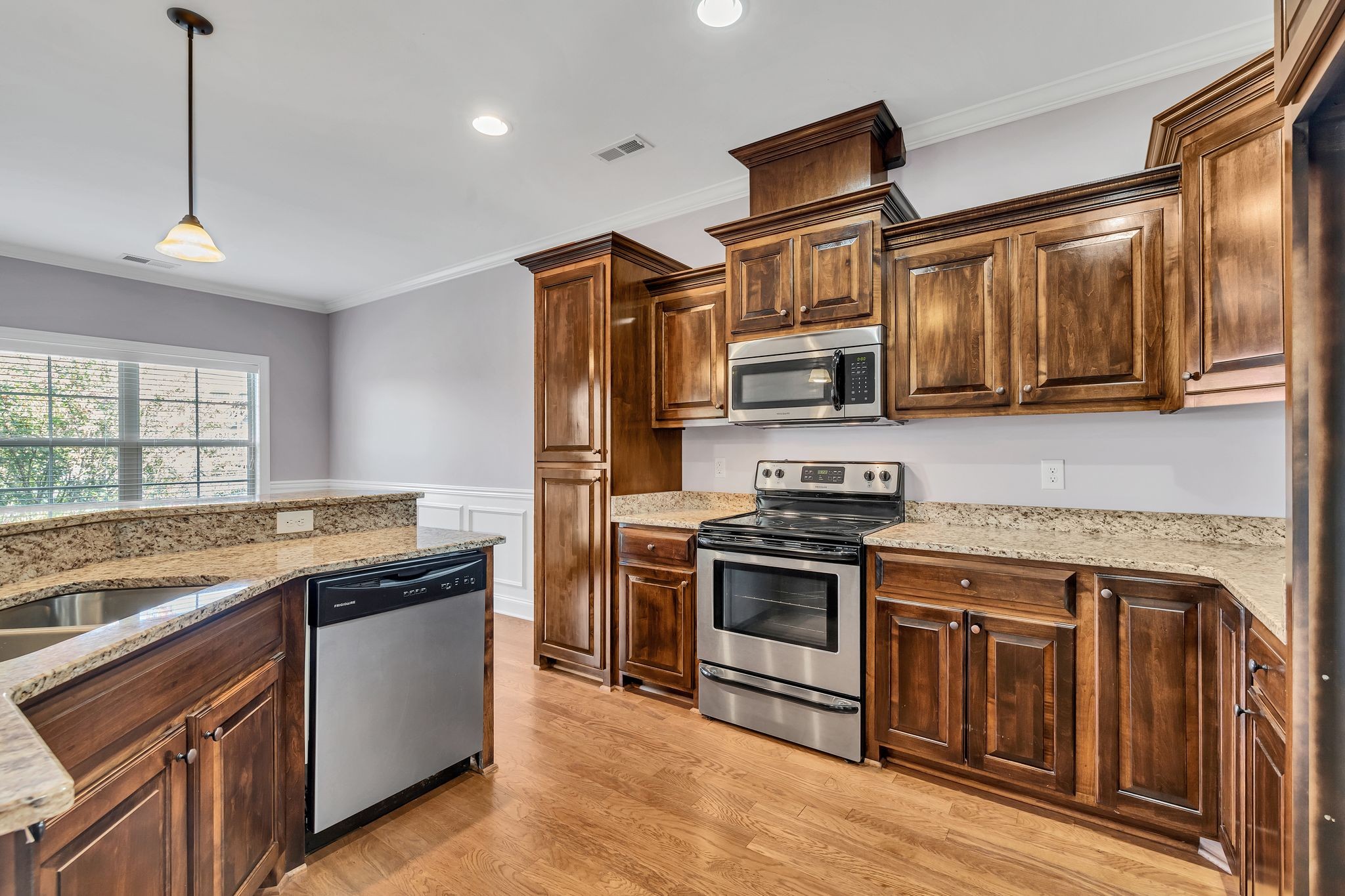 5502 Reflection Road Smyrna, TN 37167 - Photo 8 of 36 a kitchen with stainless steel appliances granite countertop a stove a sink and a microwave