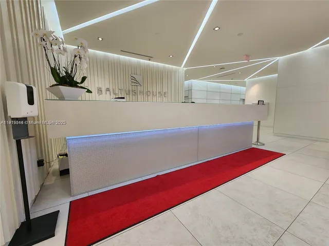 a living room with furniture a table and a large window