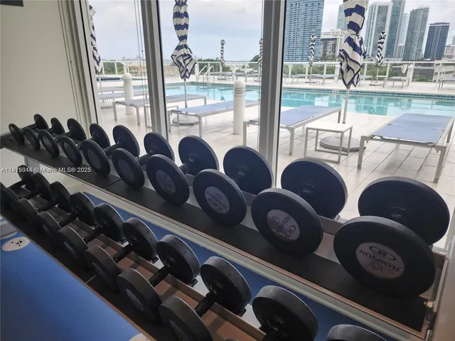 a room with gym equipment and a large window