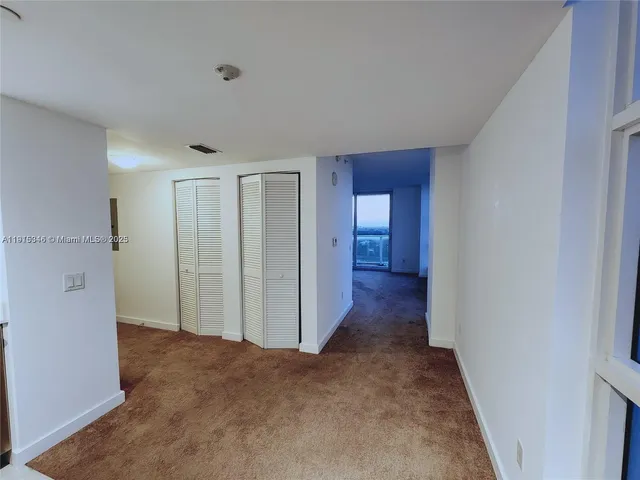 a view of a big room with windows