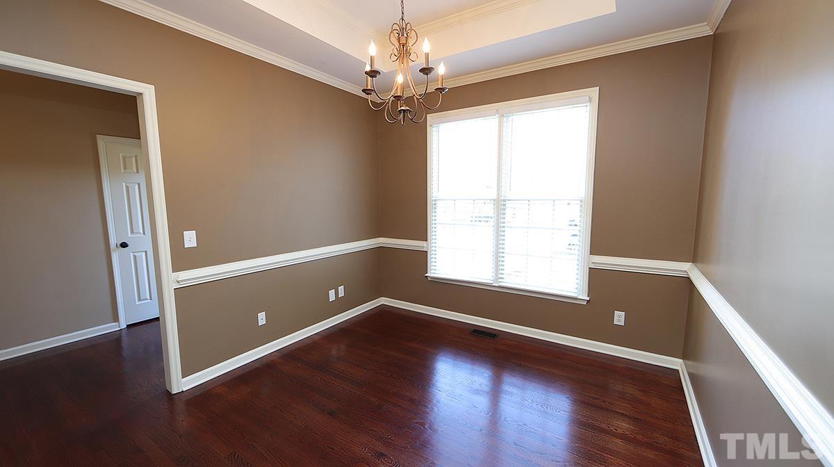 1203 Patterson Grove Road Apex, NC 27502 - Photo 2 of 11 Separate formal dining room features trey ceiling and chair rail.