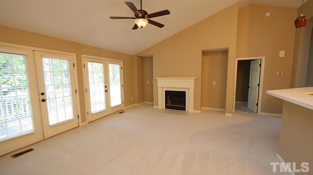 1203 Patterson Grove Road Apex, NC 27502 - Photo 3 of 11 Spacious family room has vaulted ceiling and is open to kitchen. French door leads to deck.