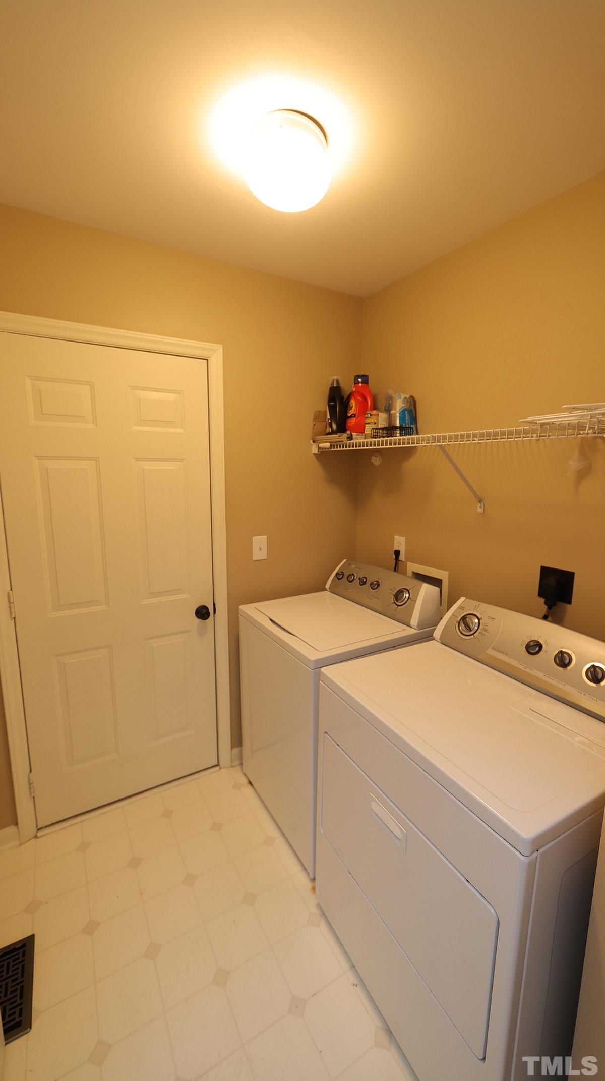 1203 Patterson Grove Road Apex, NC 27502 - Photo 6 of 11 Enter the laundry room from the two-car garage and proceed into the kitchen.