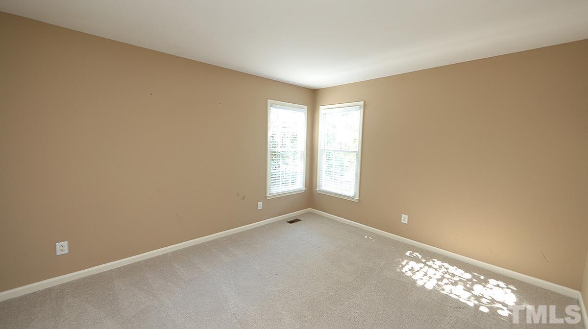 1203 Patterson Grove Road Apex, NC 27502 - Photo 9 of 11 Two secondary bedrooms are across family room from primary bedroom.