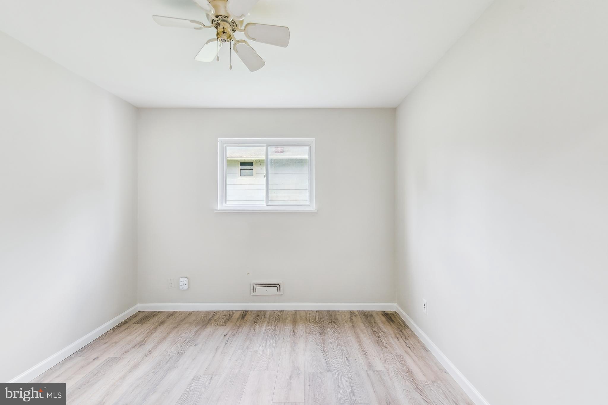 8148 Scotts Level Road Pikesville, MD 21208 - Photo 21 of 36 an empty room with a window and a fan