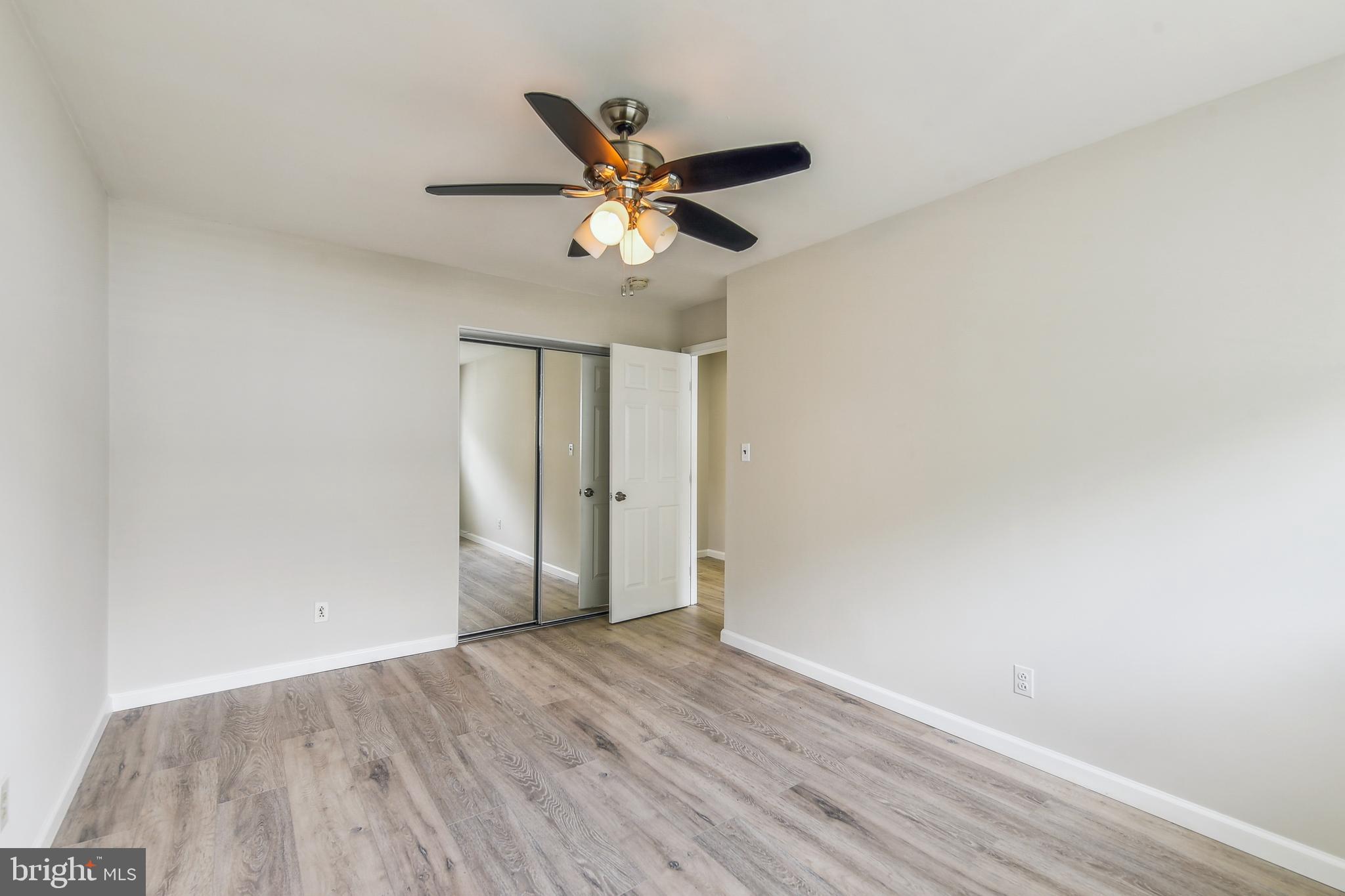 8148 Scotts Level Road Pikesville, MD 21208 - Photo 23 of 36 a view of a ceiling fan with wooden floor