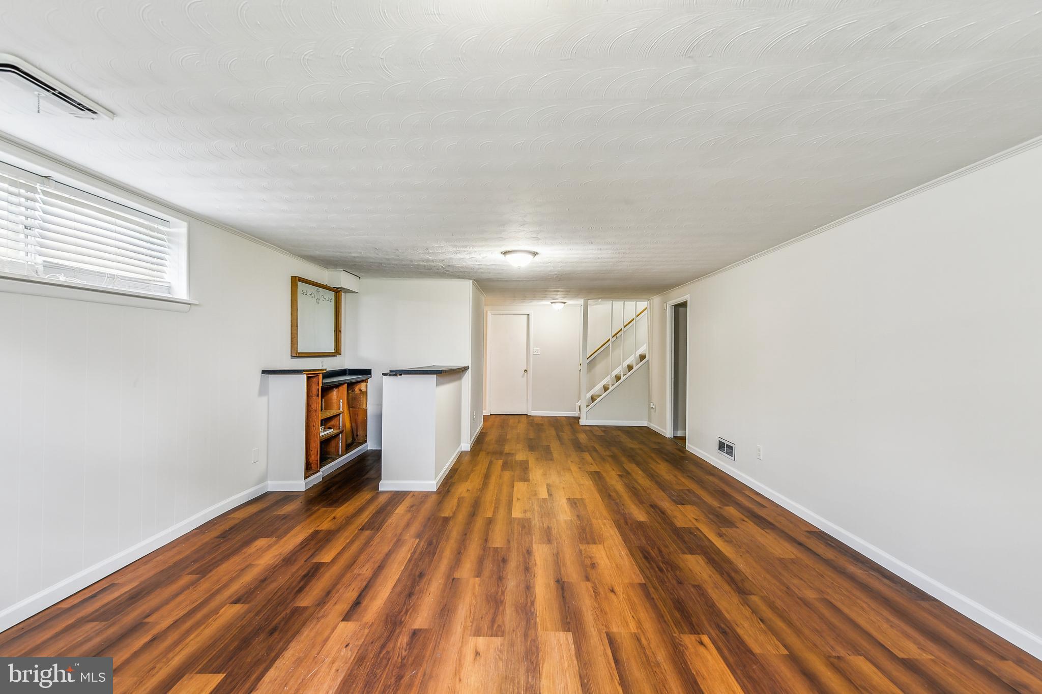 8148 Scotts Level Road Pikesville, MD 21208 - Photo 27 of 36 a view of empty room with wooden floor