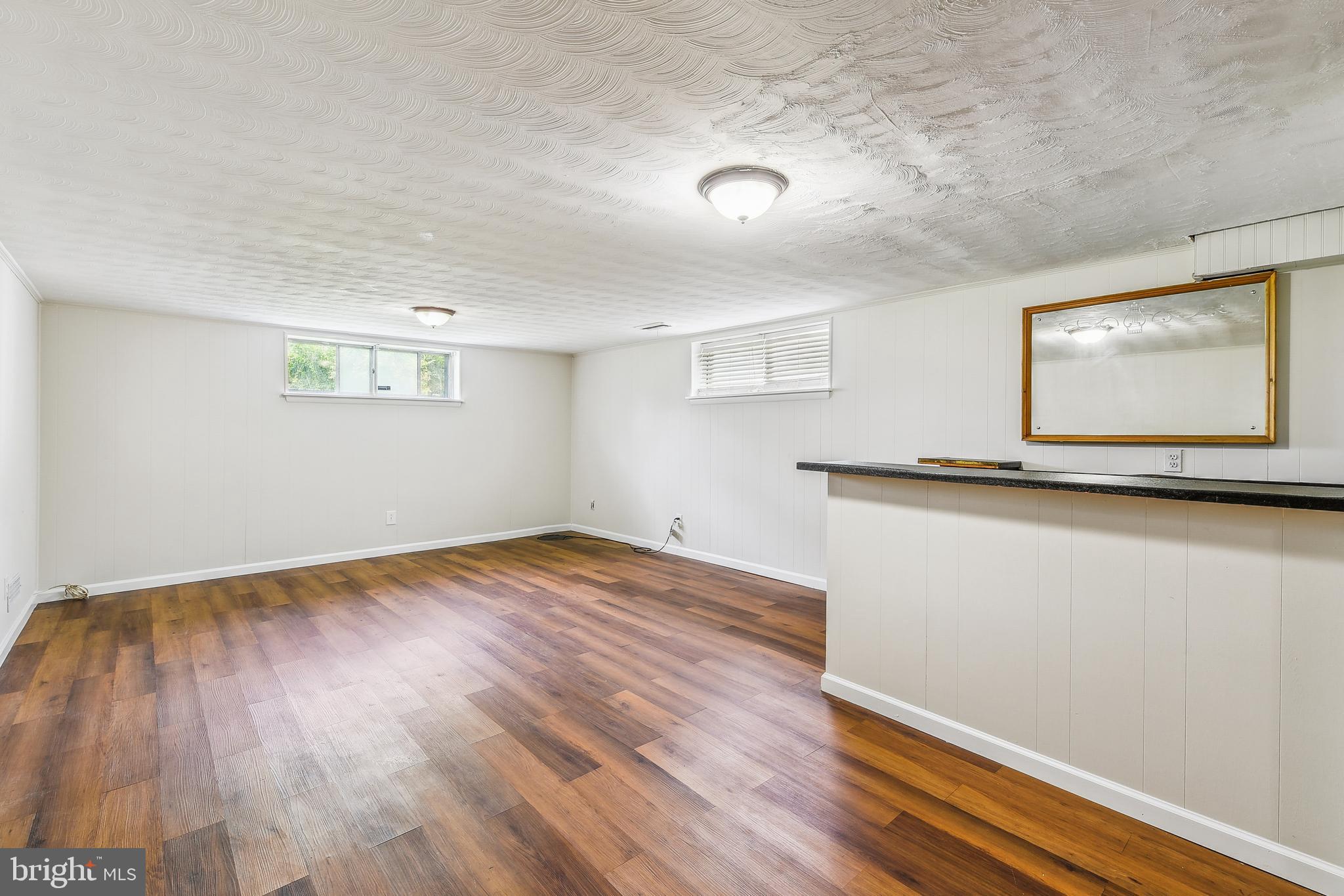 8148 Scotts Level Road Pikesville, MD 21208 - Photo 28 of 36 a view of empty room with wooden floor