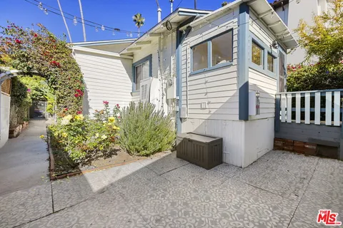 a view of a house with a yard and sitting area