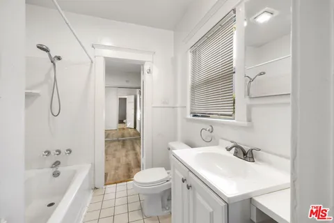 a bathroom with a sink toilet tub and shower