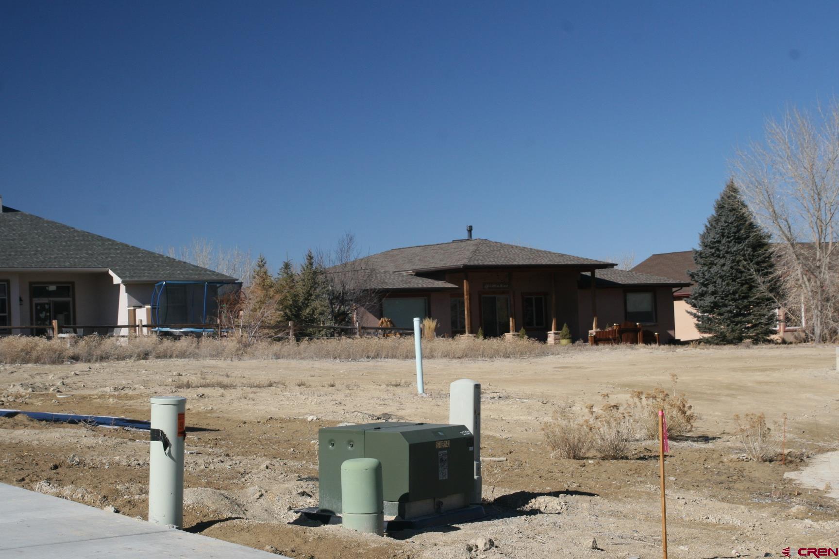 Tbd Mocha Court Montrose, CO 81401 - Photo 6 of 18 a backyard of a house with table and chairs under an umbrella