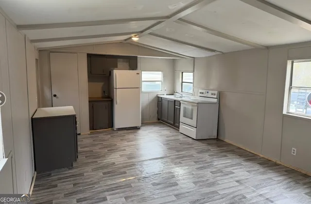 a kitchen with a sink cabinets and stainless steel appliances