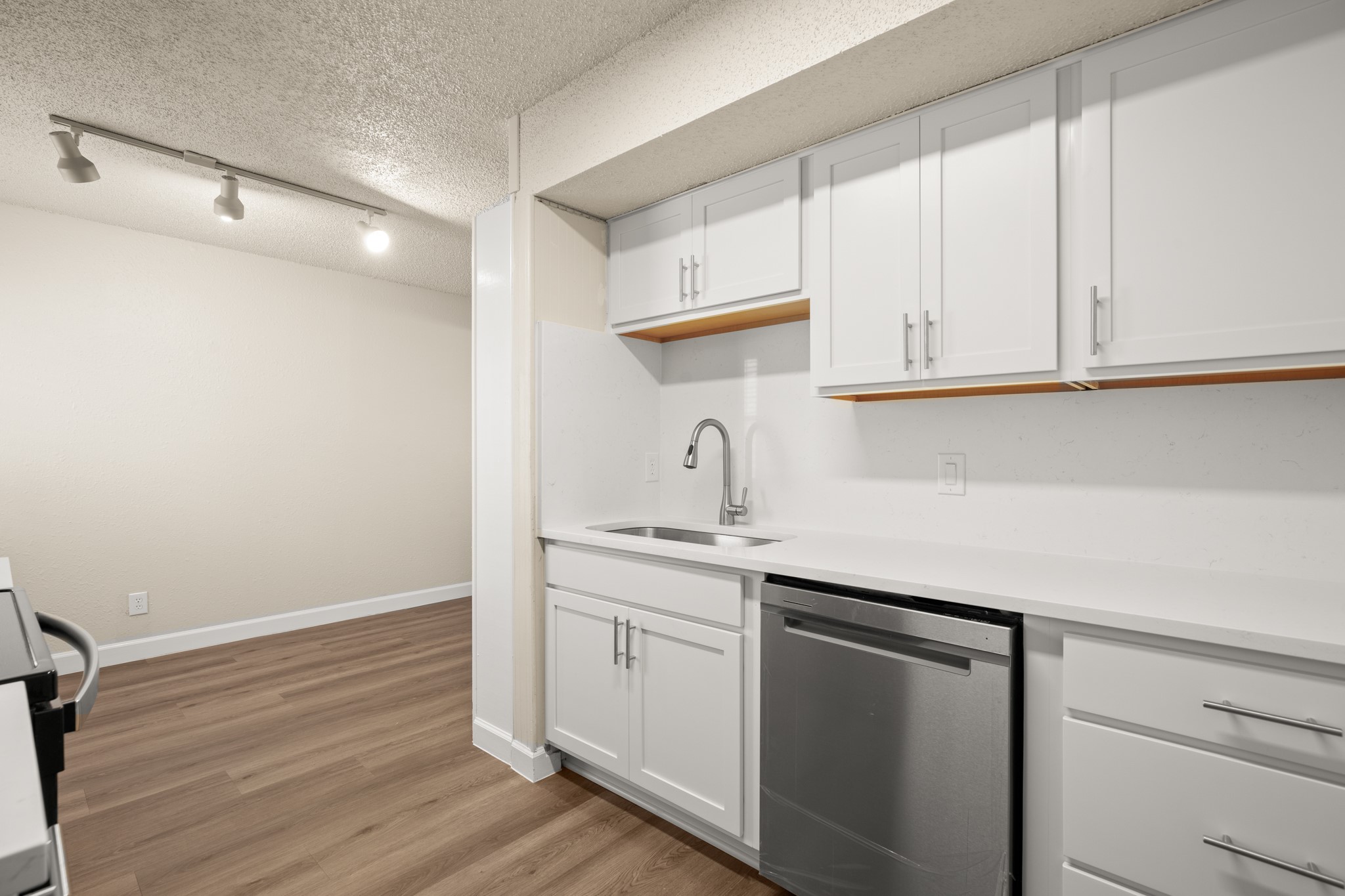 2408 Longview Street, Unit 112 Austin, TX 78705 - Photo 6 of 15 a kitchen with a sink cabinets and wooden floor
