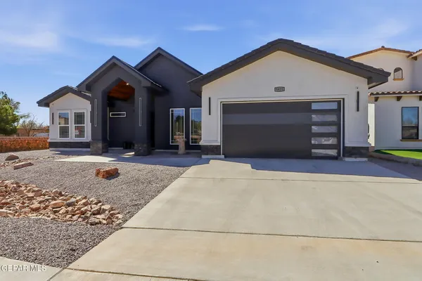 a front view of a house with garage