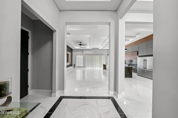 a kitchen with stainless steel appliances granite countertop a sink a stove and a wooden cabinets