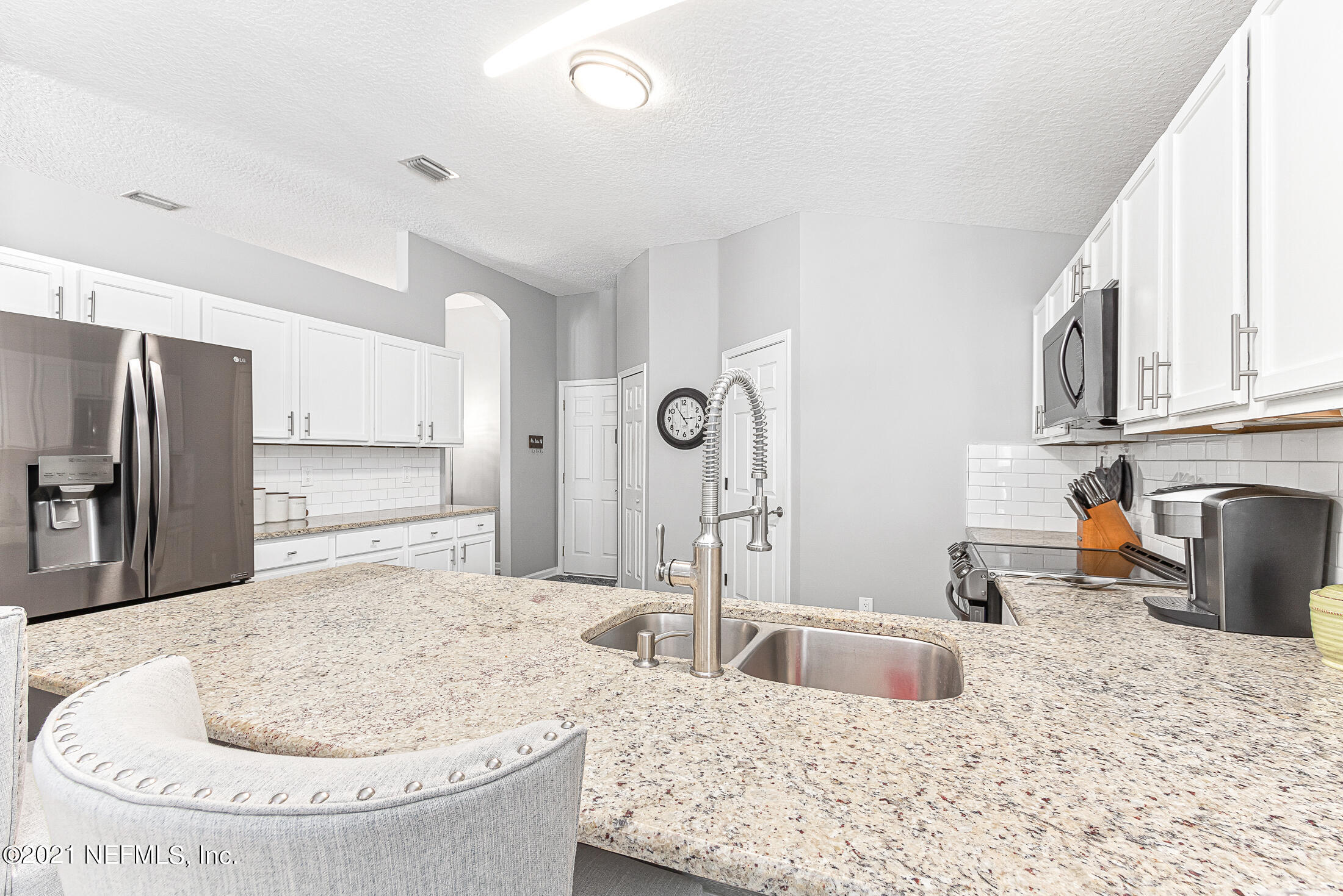 856 Crystal Spring Way St. Augustine, FL 32092 - Photo 15 of 54 a kitchen with stainless steel appliances granite countertop a sink and a refrigerator