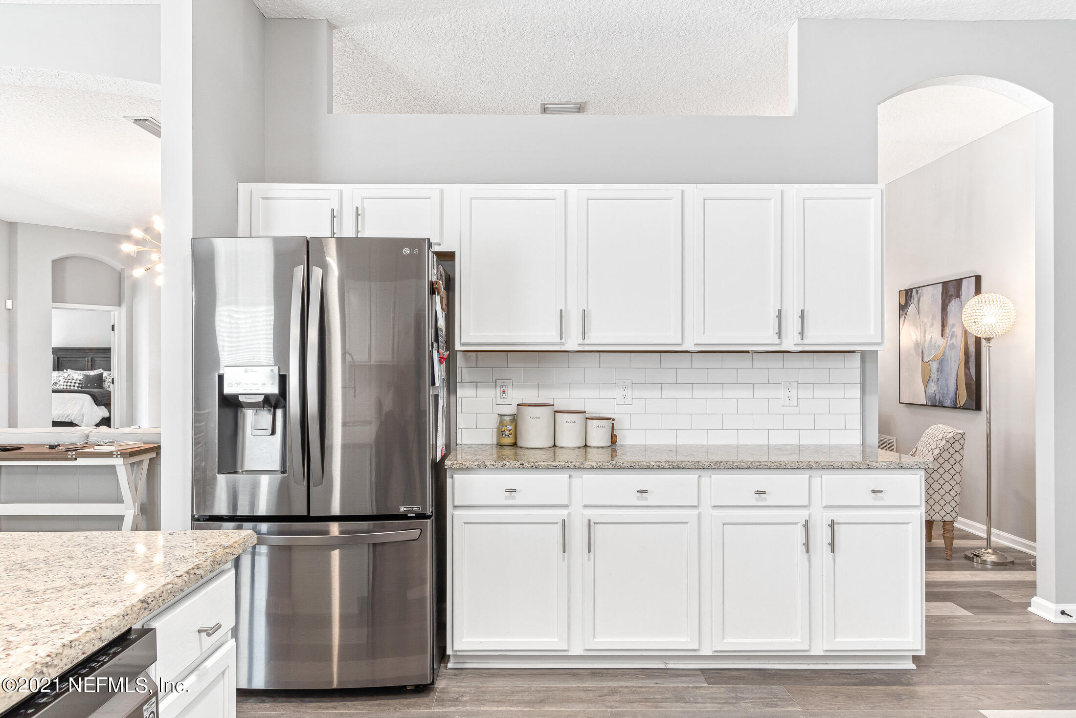 856 Crystal Spring Way St. Augustine, FL 32092 - Photo 16 of 54 a kitchen with white cabinets and stainless steel appliances