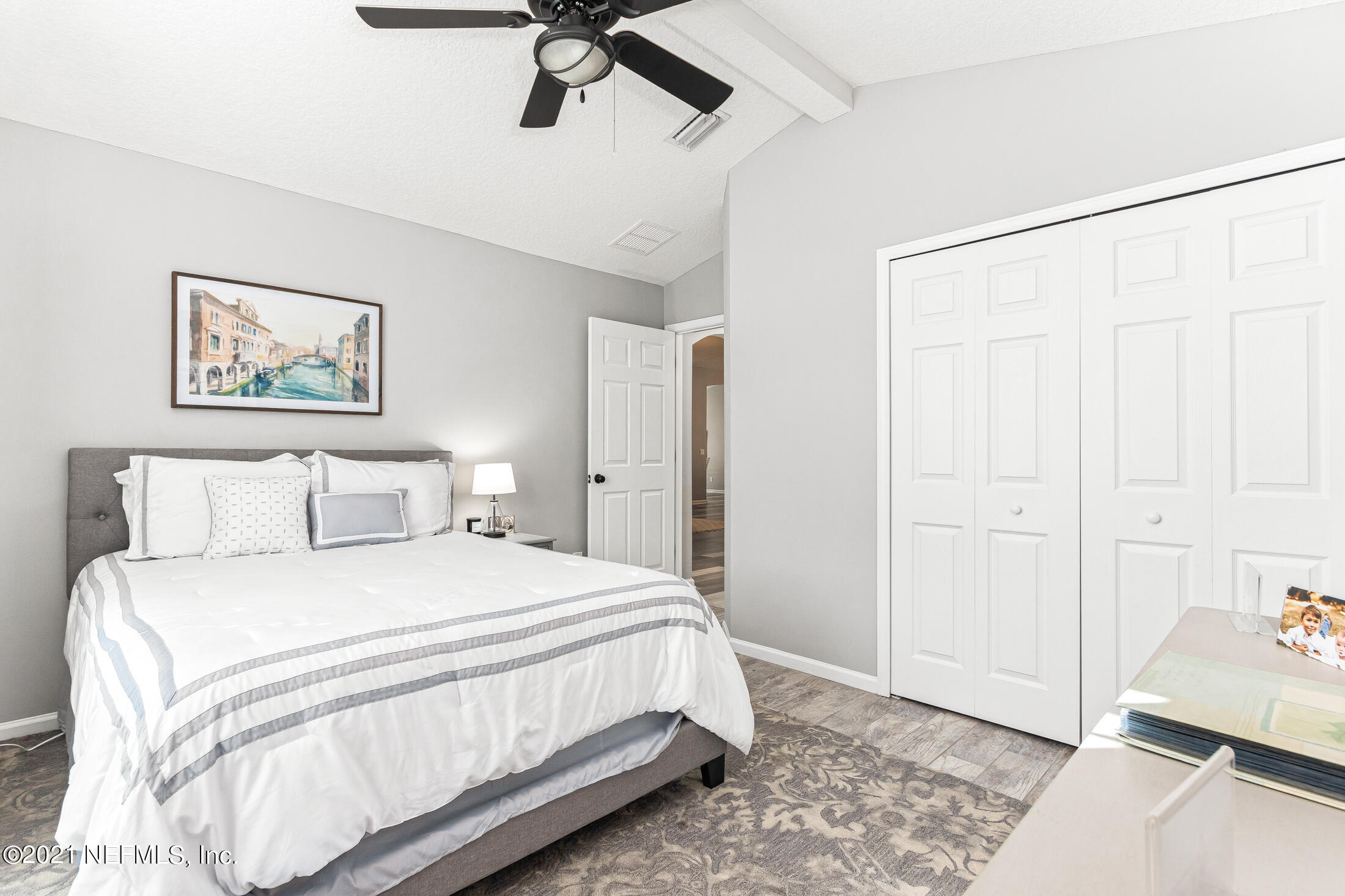 856 Crystal Spring Way St. Augustine, FL 32092 - Photo 20 of 54 a bedroom with a bed and a chandelier