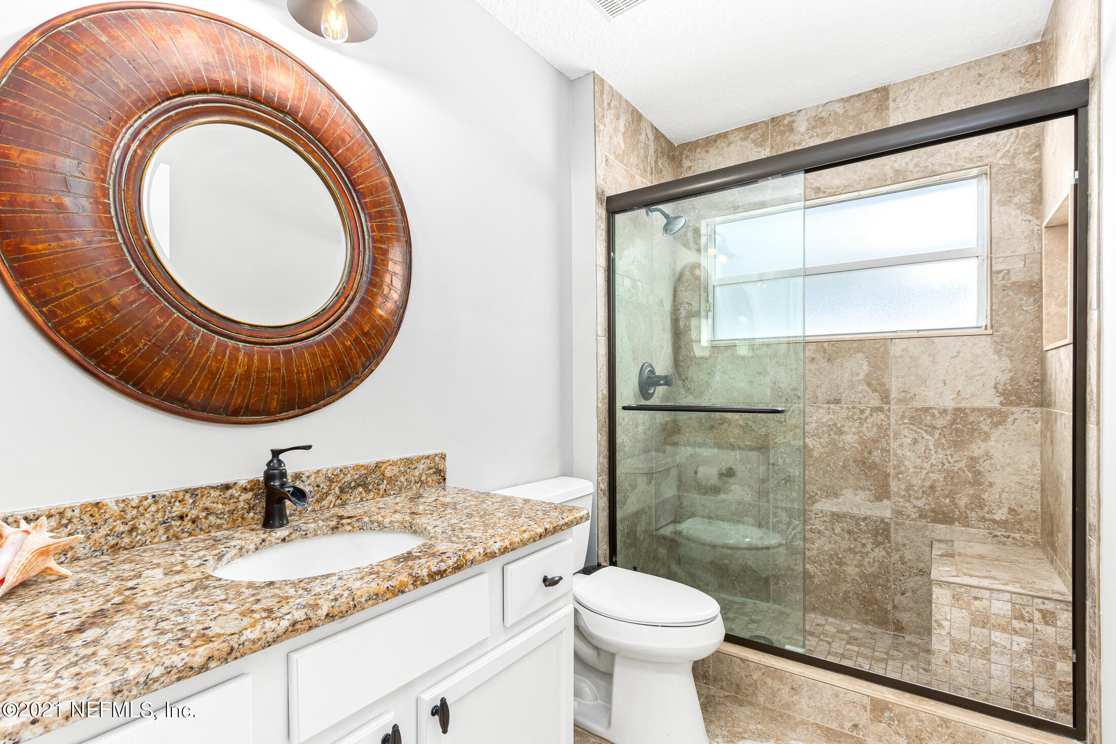 856 Crystal Spring Way St. Augustine, FL 32092 - Photo 21 of 54 a bathroom with a granite countertop sink a mirror and a toilet