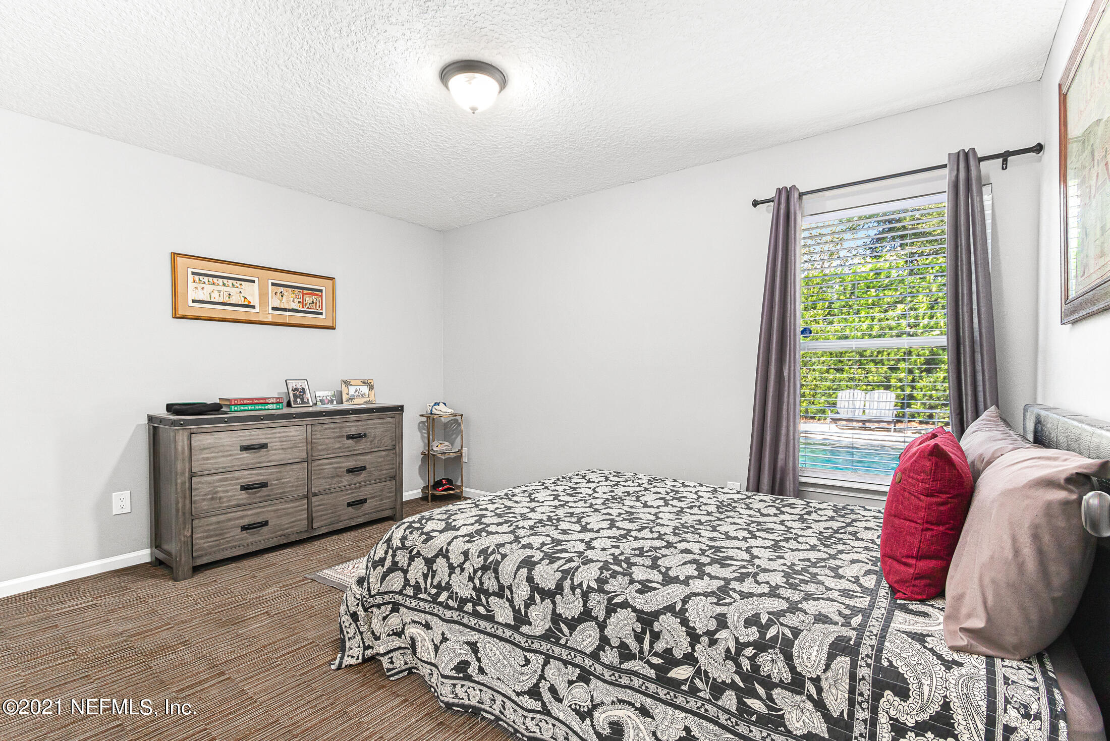 856 Crystal Spring Way St. Augustine, FL 32092 - Photo 25 of 54 a bedroom with a bed and a window