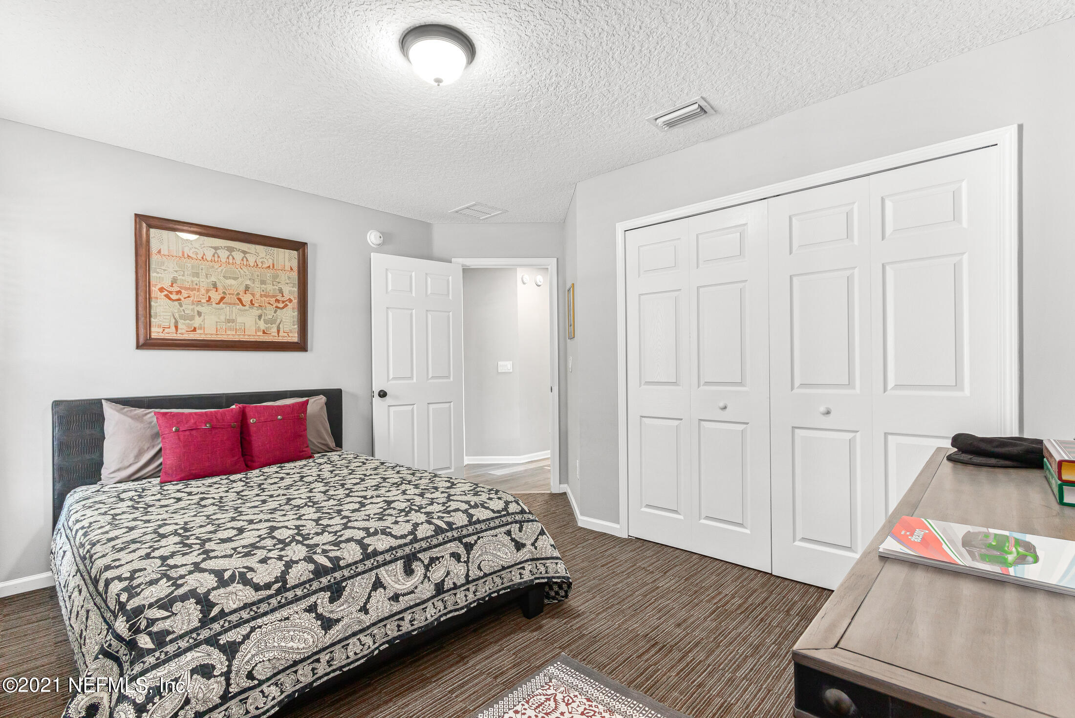856 Crystal Spring Way St. Augustine, FL 32092 - Photo 26 of 54 a bedroom with a bed and wooden floor