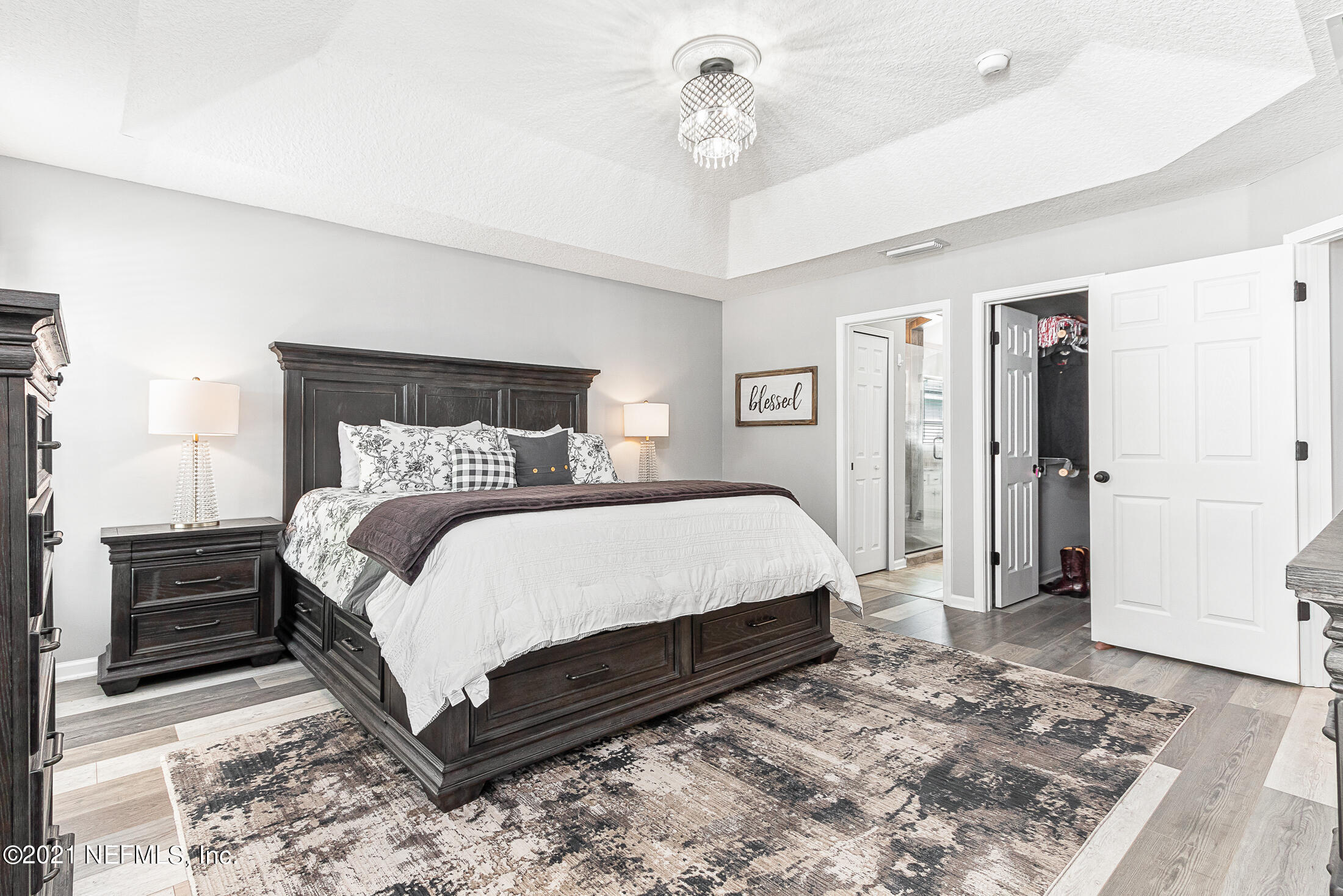 856 Crystal Spring Way St. Augustine, FL 32092 - Photo 28 of 54 a bedroom with a bed and a refrigerator