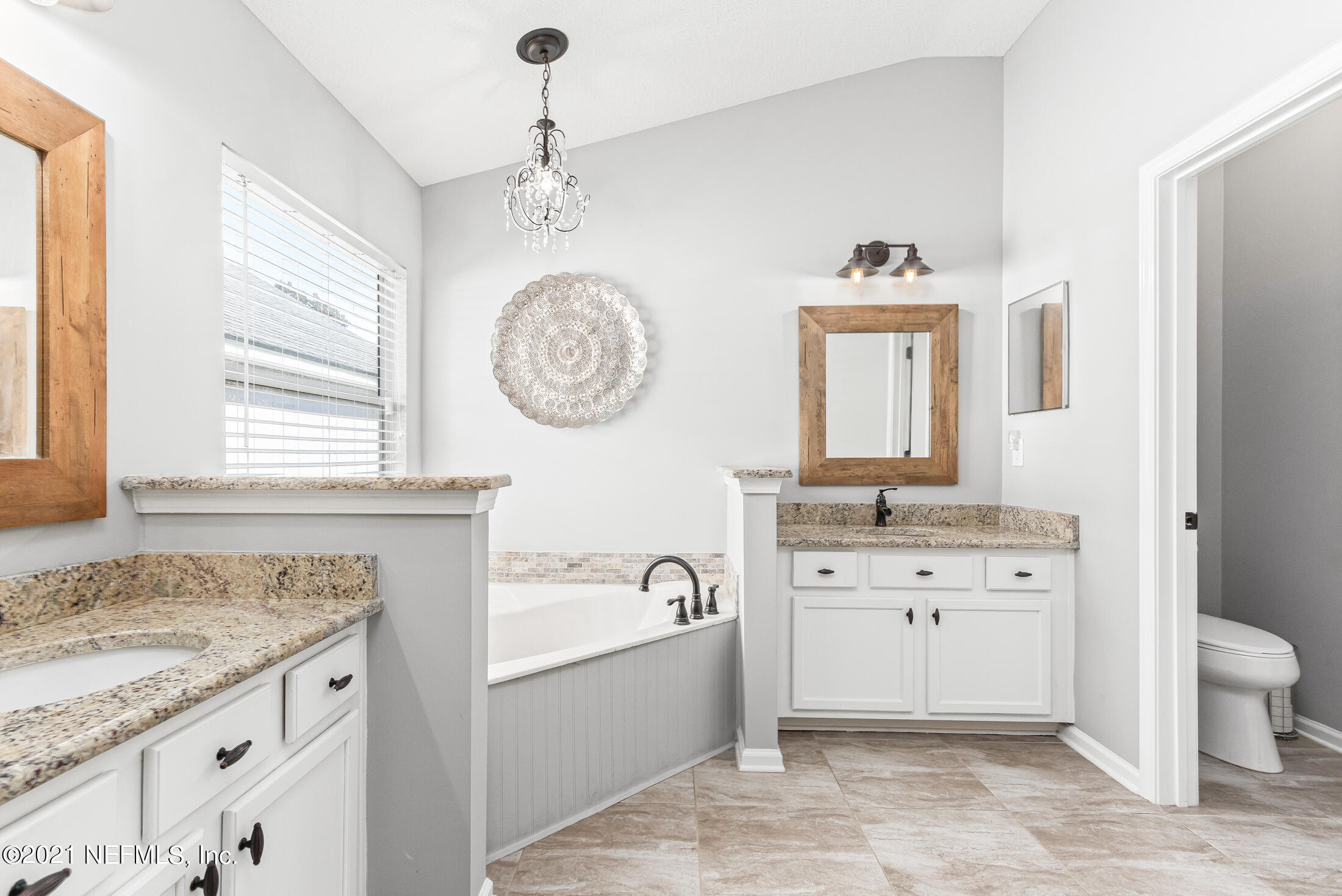 856 Crystal Spring Way St. Augustine, FL 32092 - Photo 30 of 54 a spacious bathroom with a granite countertop sink mirror toilet and a bathtub