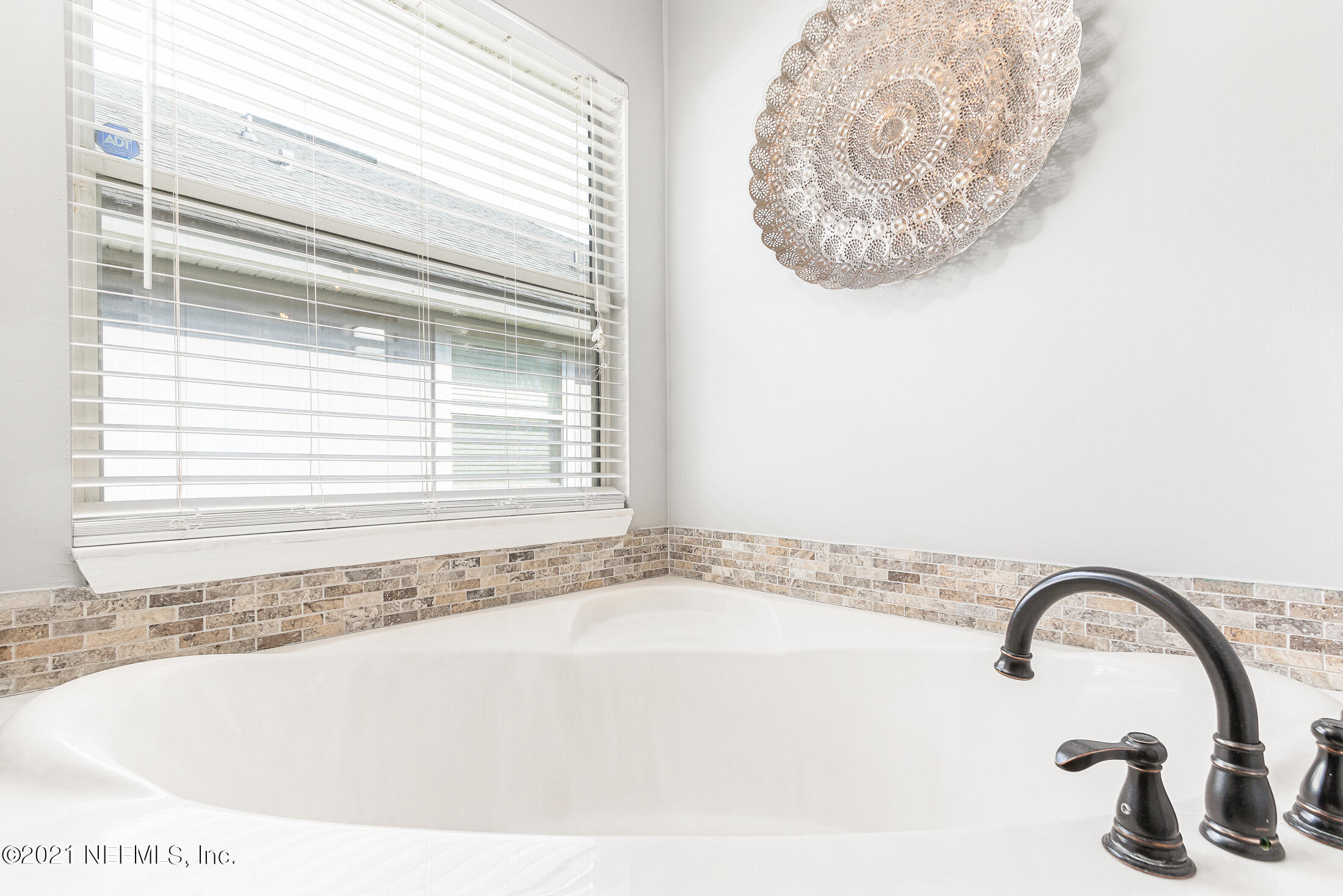 856 Crystal Spring Way St. Augustine, FL 32092 - Photo 33 of 54 a bath tub sitting in a bathroom next to a window