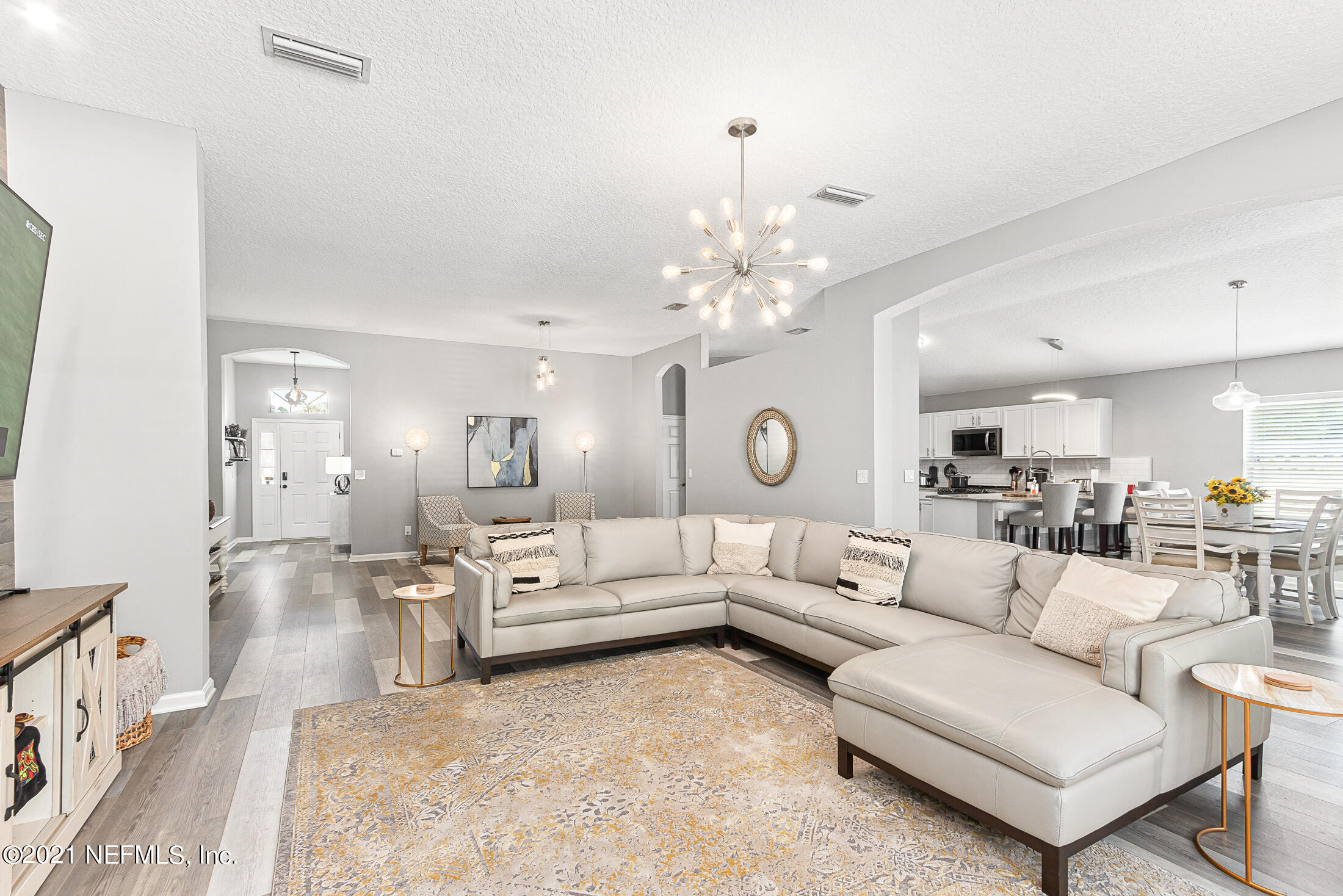 856 Crystal Spring Way St. Augustine, FL 32092 - Photo 5 of 54 a living room with furniture and a chandelier