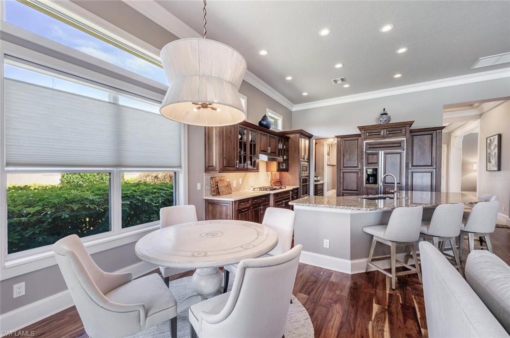 3086 Aviamar Circle Naples, FL 34114 - Photo 15 of 50 a kitchen with a table and chairs