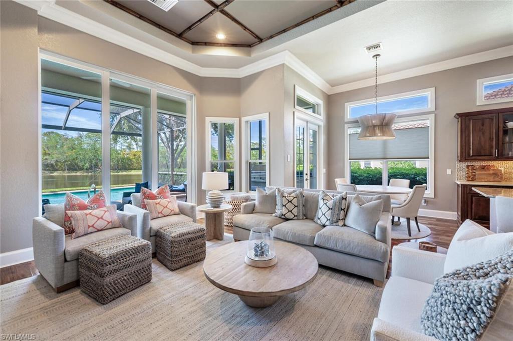 3086 Aviamar Circle Naples, FL 34114 - Photo 19 of 50 a living room with furniture and a large window