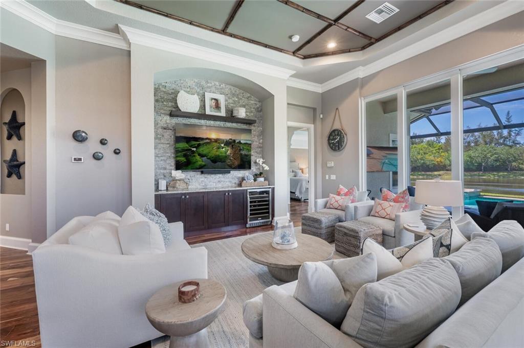 3086 Aviamar Circle Naples, FL 34114 - Photo 20 of 50 a living room with furniture and a large window