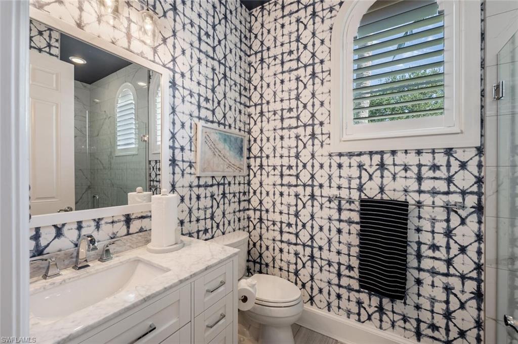 3086 Aviamar Circle Naples, FL 34114 - Photo 35 of 50 a bathroom with a sink a toilet and shower curtain