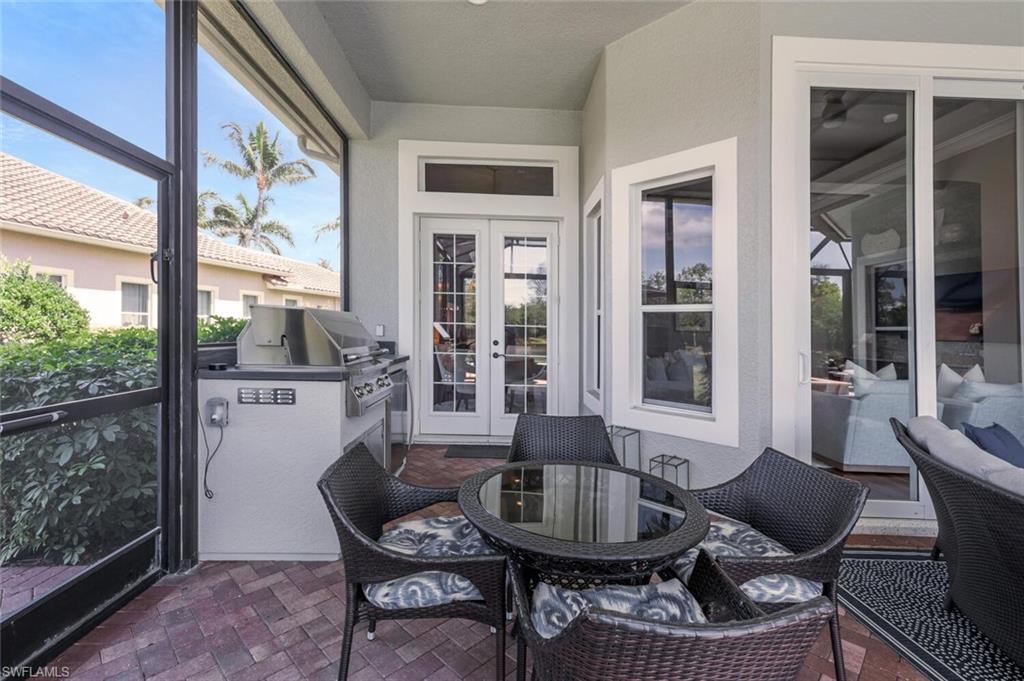 3086 Aviamar Circle Naples, FL 34114 - Photo 37 of 50 a view of a dining room with furniture large windows and wooden floor