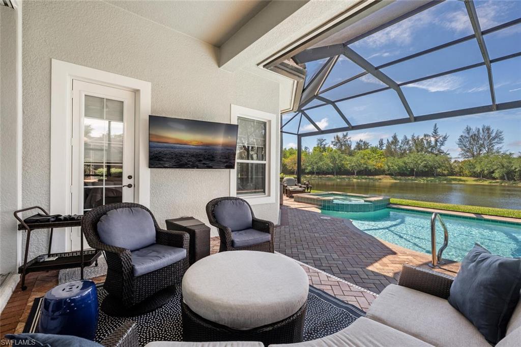 3086 Aviamar Circle Naples, FL 34114 - Photo 39 of 50 a living room with furniture and a floor to ceiling window