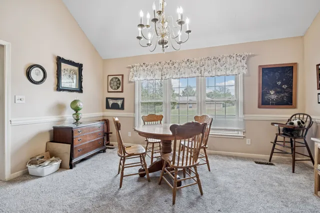 a large kitchen with stainless steel appliances granite countertop a stove a sink dishwasher and a microwave oven with cabinets