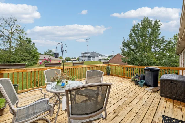 a spacious bedroom with a bed a chandelier and a couch