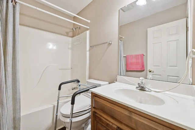 a living room with lots of furniture and kitchen view