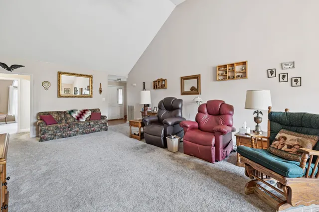 a dining room with furniture and chandelier kitchen view